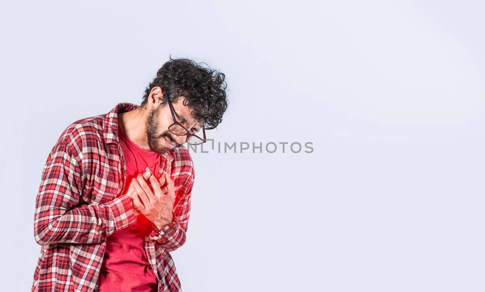 Man with heart pain on isolated background, man with chest pain isolated, man with tachycardia, young man with chest pain isolated