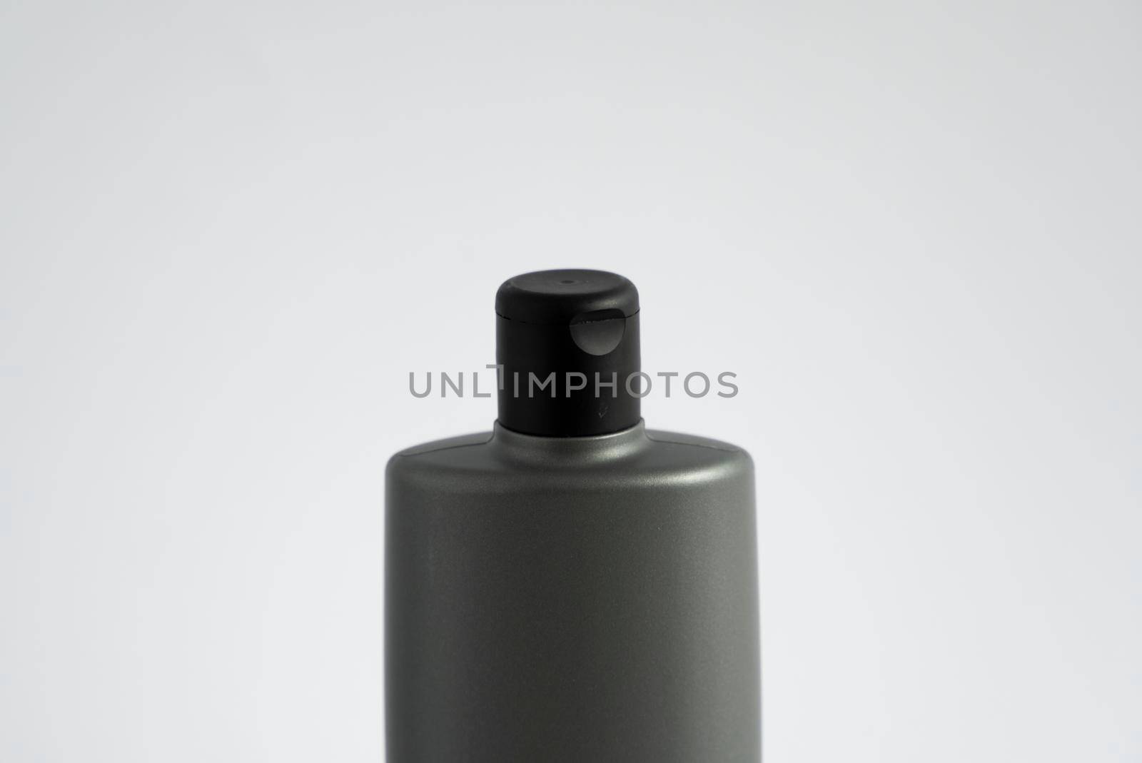 Black shampoo packaging mockup. Vertical empty plastic cosmetic package for man, isolated on white background. Container of conditioner, hair rinse. by vovsht