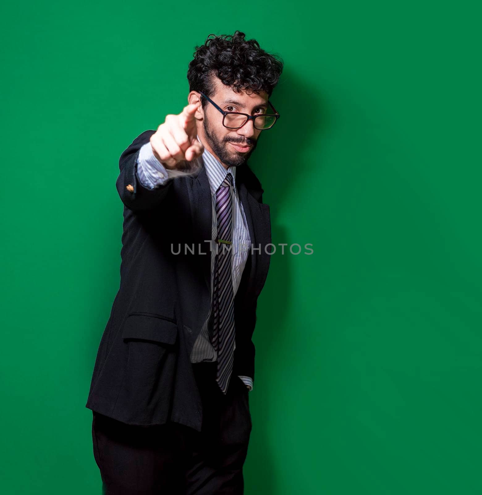 Young businessman with positive attitude, friendly entrepreneur pointing