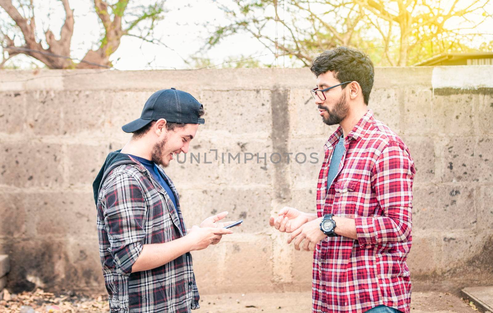 Two young people having a conversation outdoors, two friends having a conversation, concept of respect and friendly conversation by isaiphoto