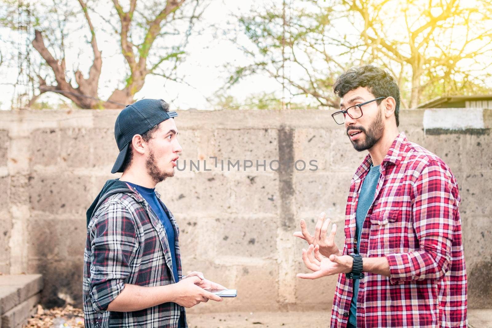 Two young people having a conversation outdoors, two friends having a conversation, concept of respect and friendly conversation