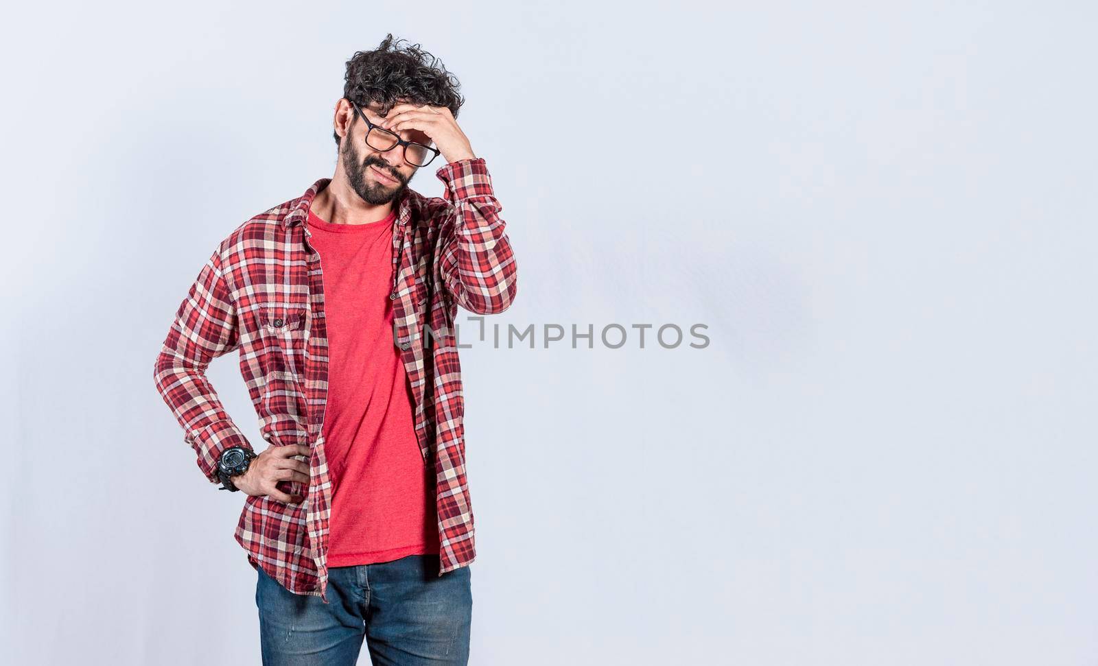 Worried man isolated, worried young man holding his forehead, tired man holding his head, man with headache by isaiphoto