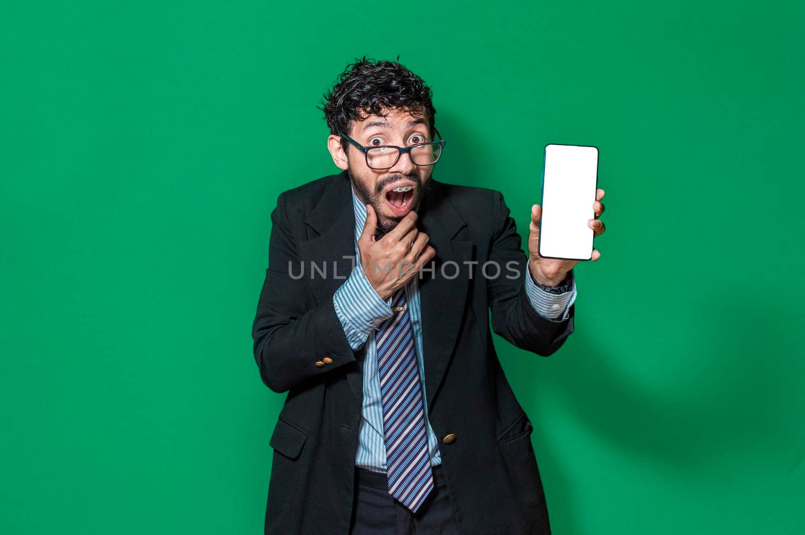 Businessman showing a cell phone from the front, happy businessman showing his cell phone isolated