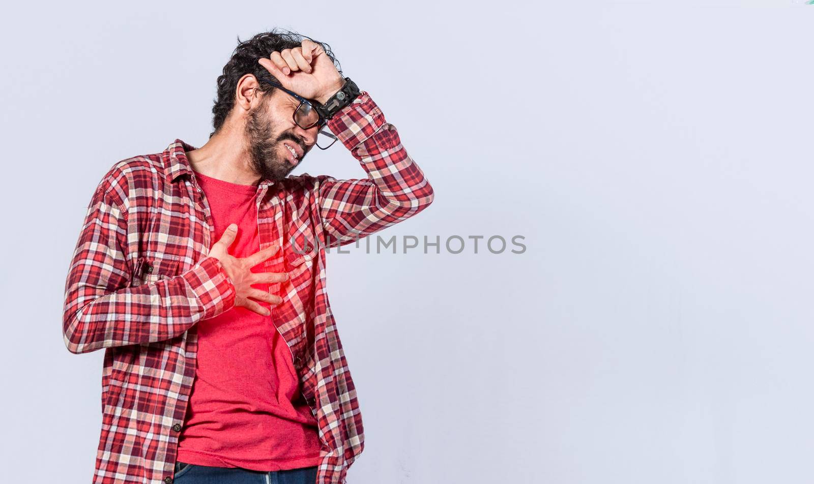 Man with heart pain on isolated background, man with chest pain isolated, man with tachycardia, young man with chest pain isolated