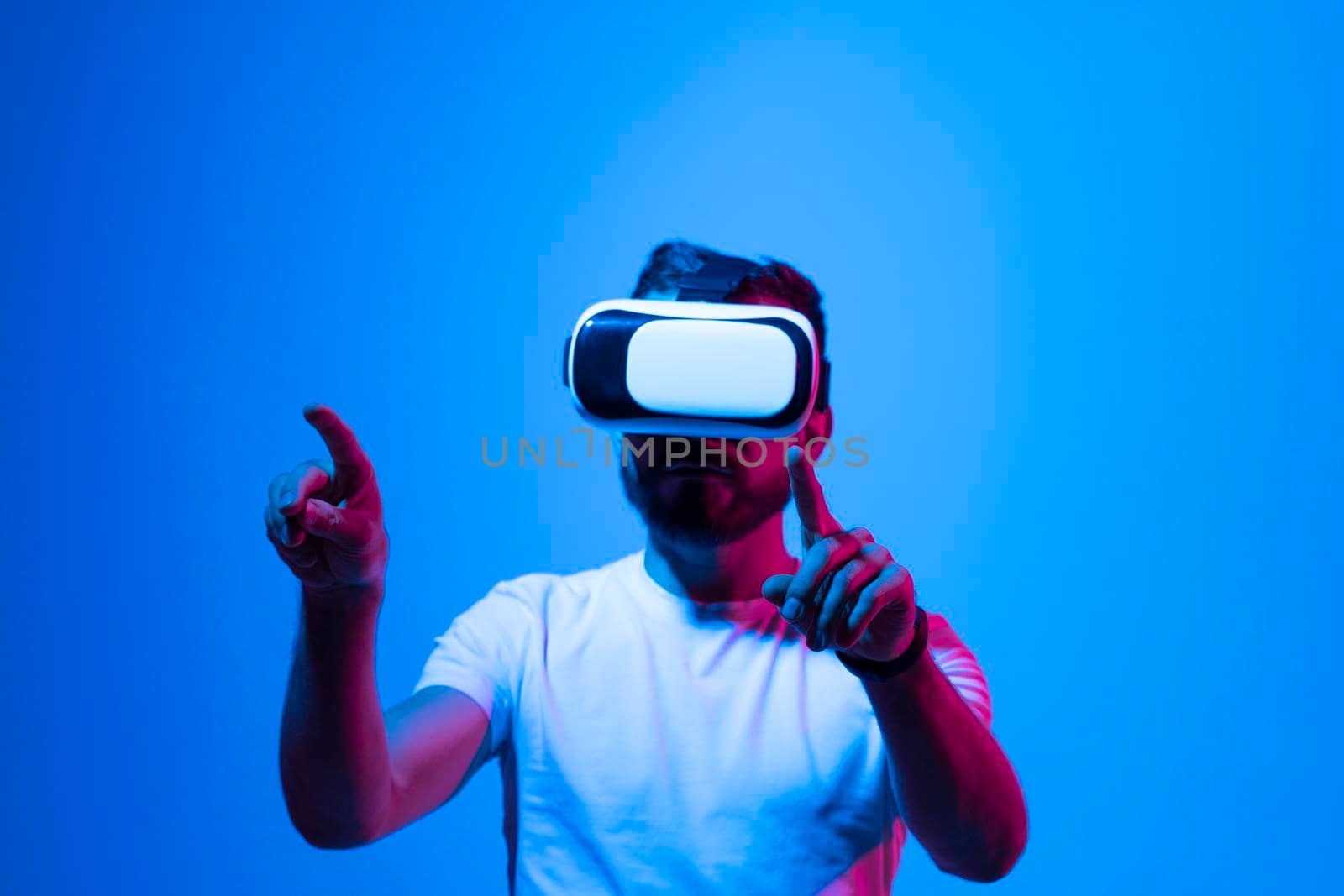 Man in virtual reality glasses. Guy wearing VR headset working in digital simulation, entertains in cyberspace. by vovsht