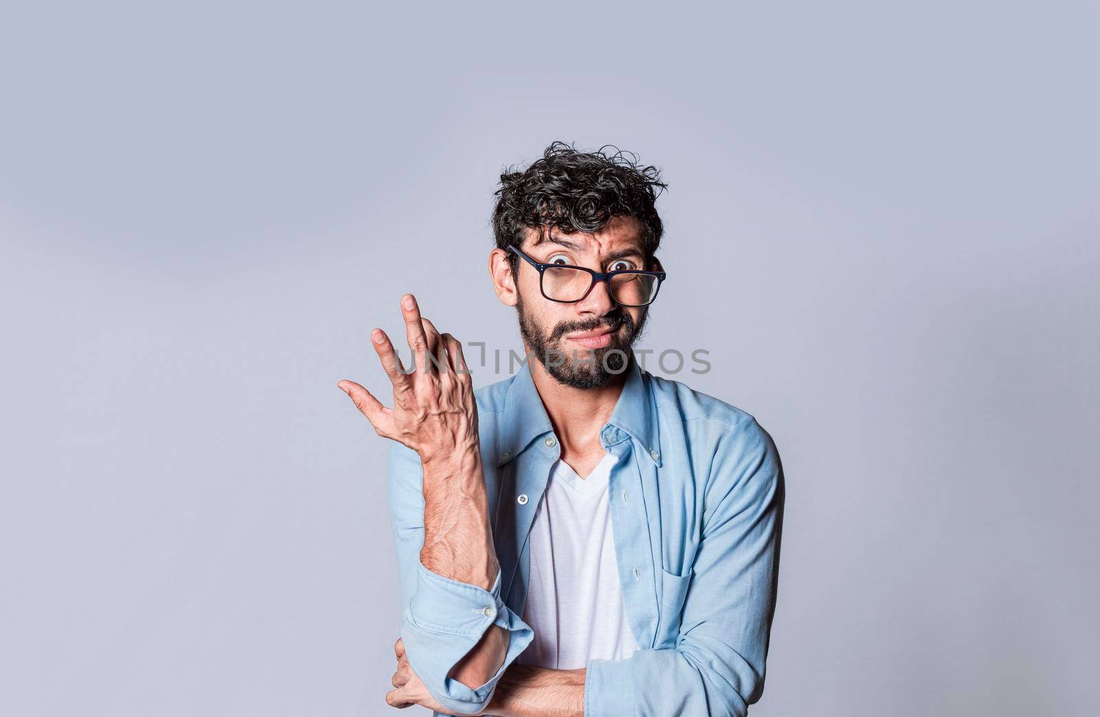 Puzzled man on isolated background, face of a puzzled and skeptical guy on isolated background by isaiphoto