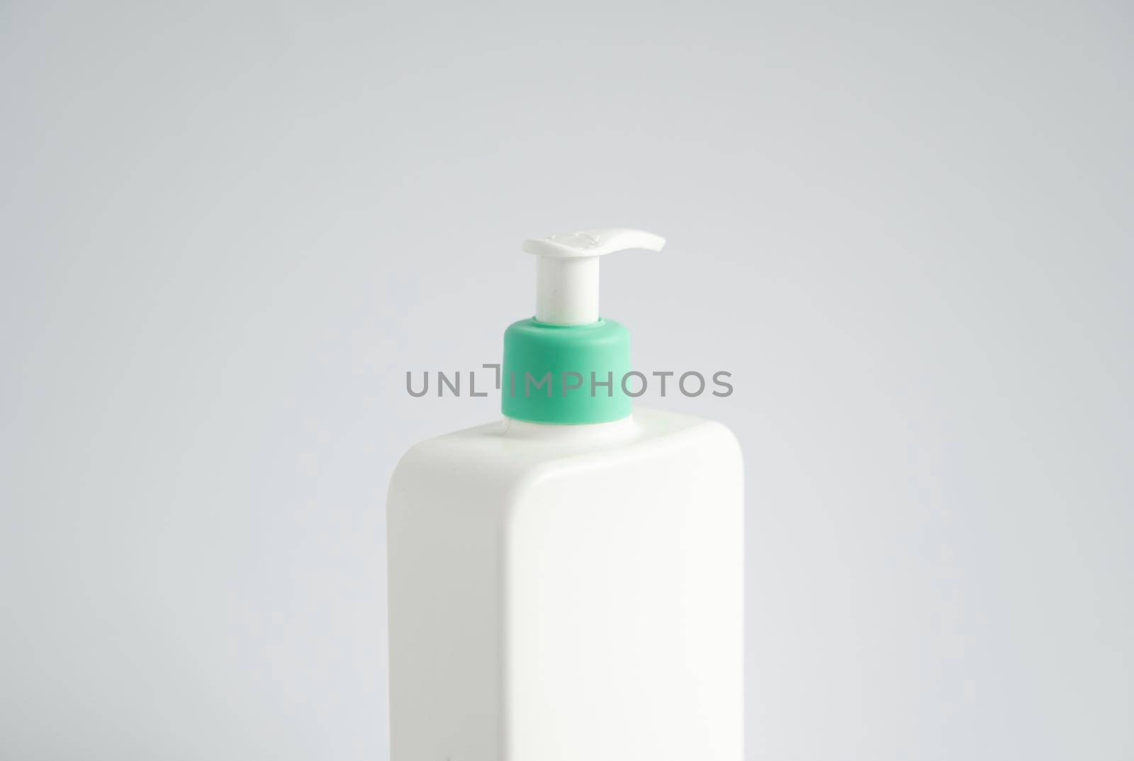 Large white plastic bottle with pump dispenser as a liquid container for gel, lotion, cream, shampoo, bath foam on white background