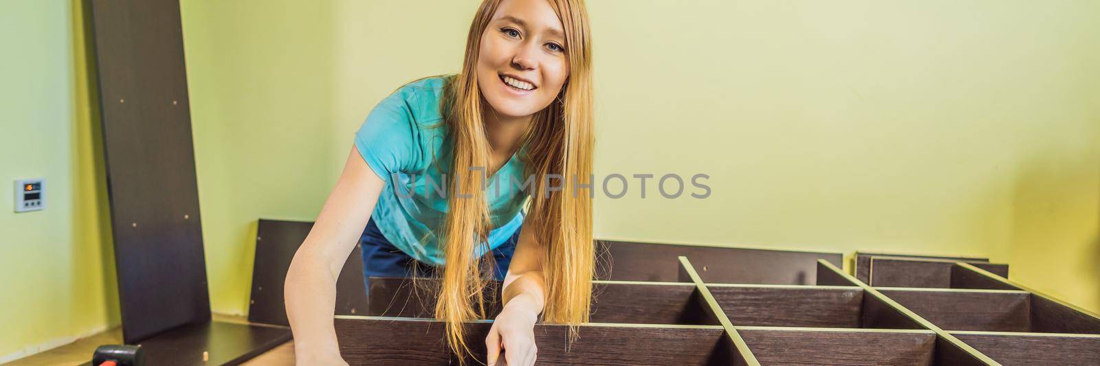 Caucasian woman using screwdriver for assembling furniture. BANNER, LONG FORMAT