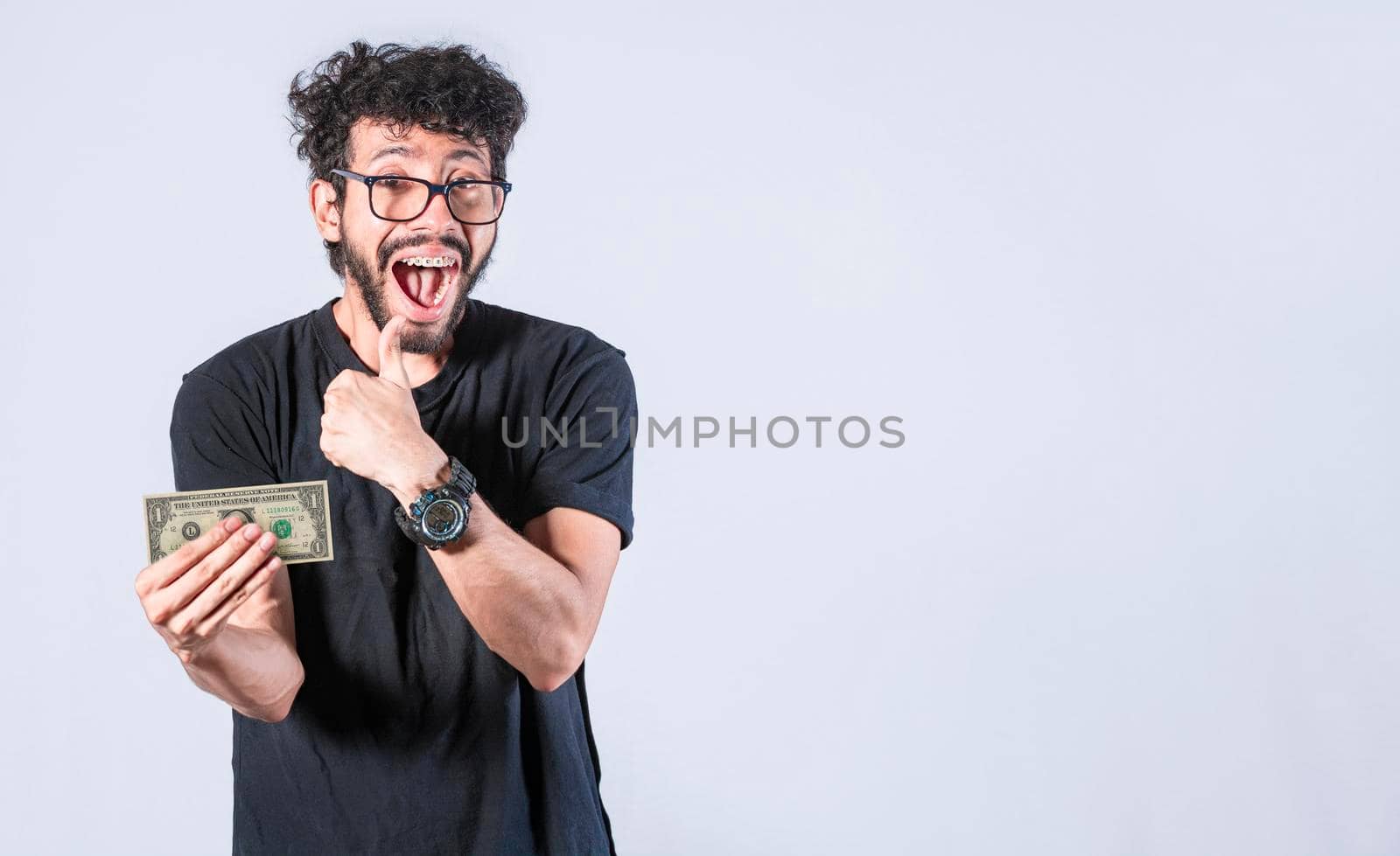 Happy man holding banknote in his hand, man with a banknote in his hand with thumb up, saving man concept, guy with money isolated