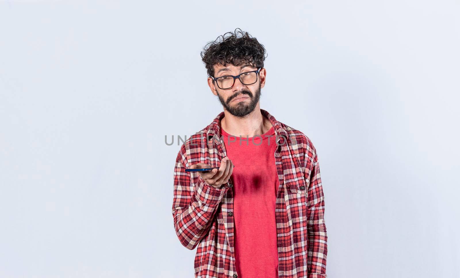 skeptical man with cell phone in hand, man with indifferent and sad face, Sad man with cell phone in hand