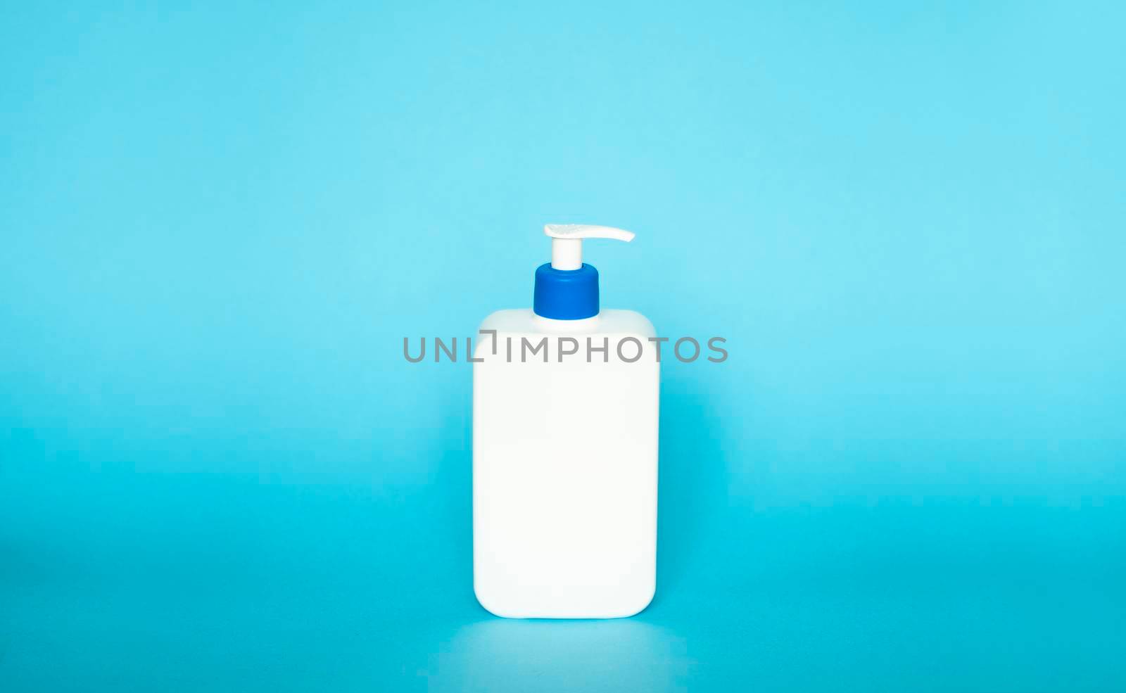 Liquid container for gel, lotion, cream, shampoo, bath foam. Cosmetic plastic bottle with blue dispenser pump on blue background. Cosmetic packaging mockup with copy space. by vovsht