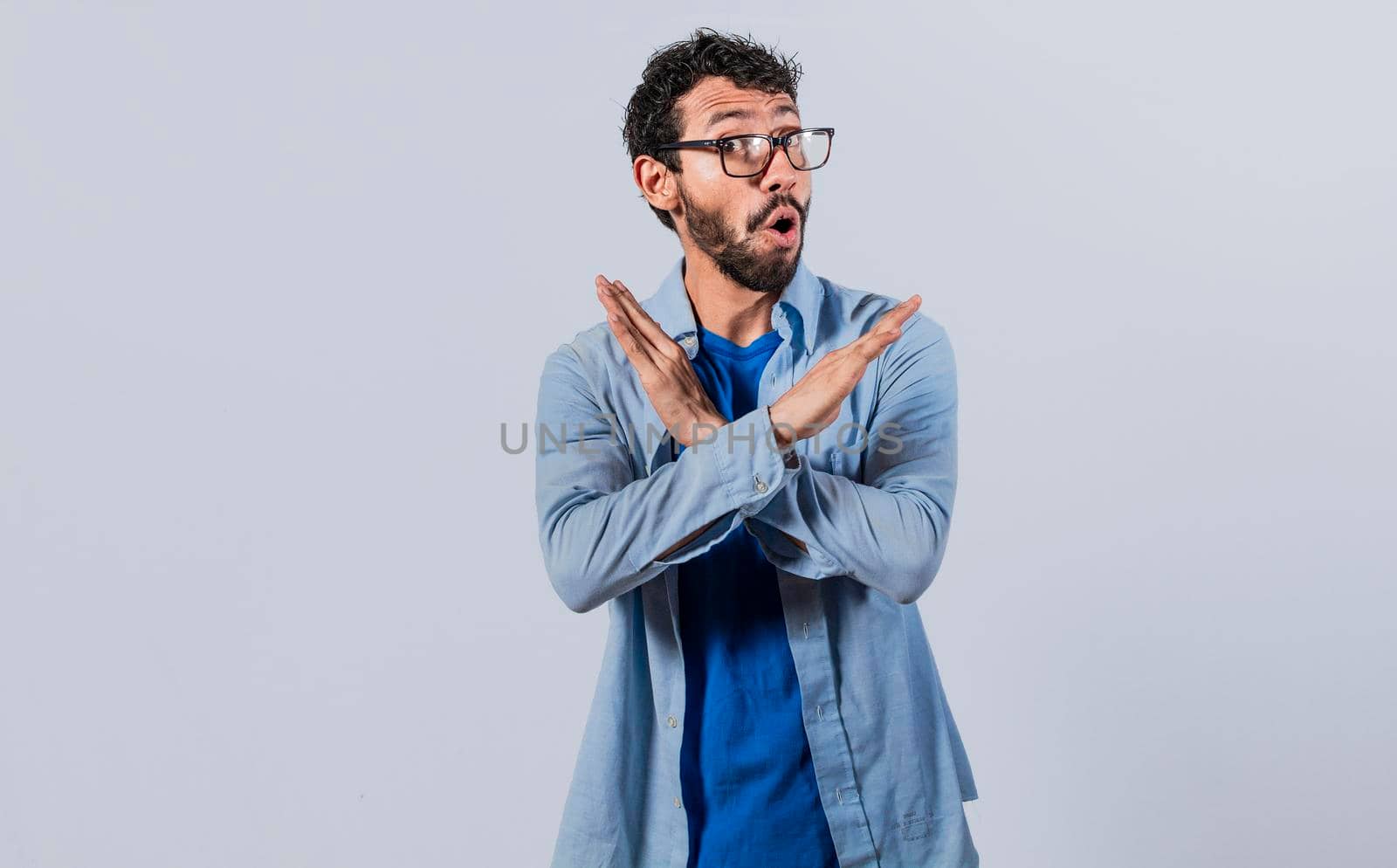 Man crossing arms in rejection, a man crossing his arms with rejection expression, concept of man rejecting
