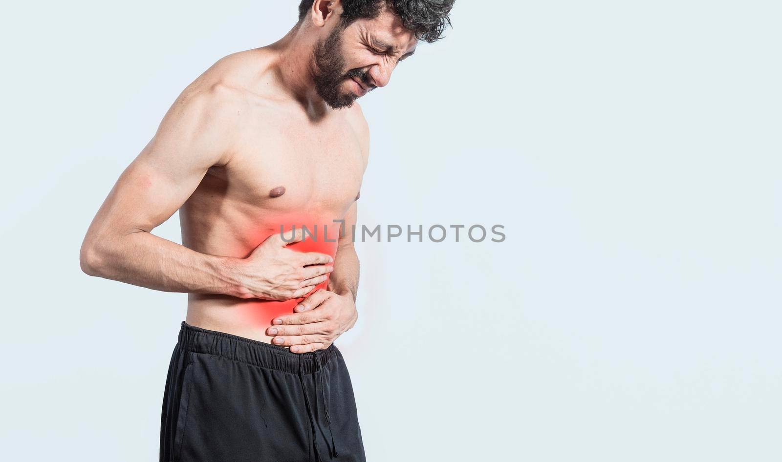 shirtless man with stomach ache, stomach problems concept, man with digestive problems, person with stomach ache, sore man holding his stomach isolated