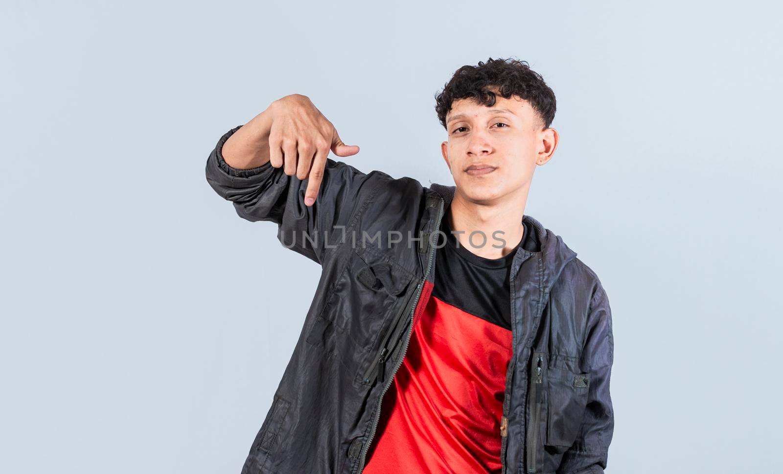 Friendly guy pointing down on isolated background, friendly guy pointing down and recommending