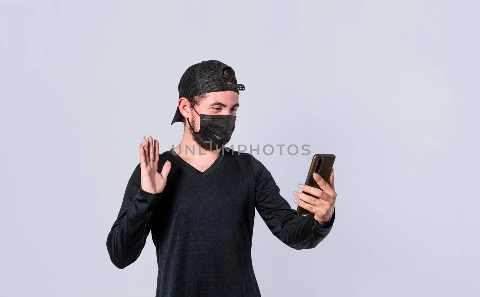 Man making video call isolated, guy making video call with face mask, face mask video call concept