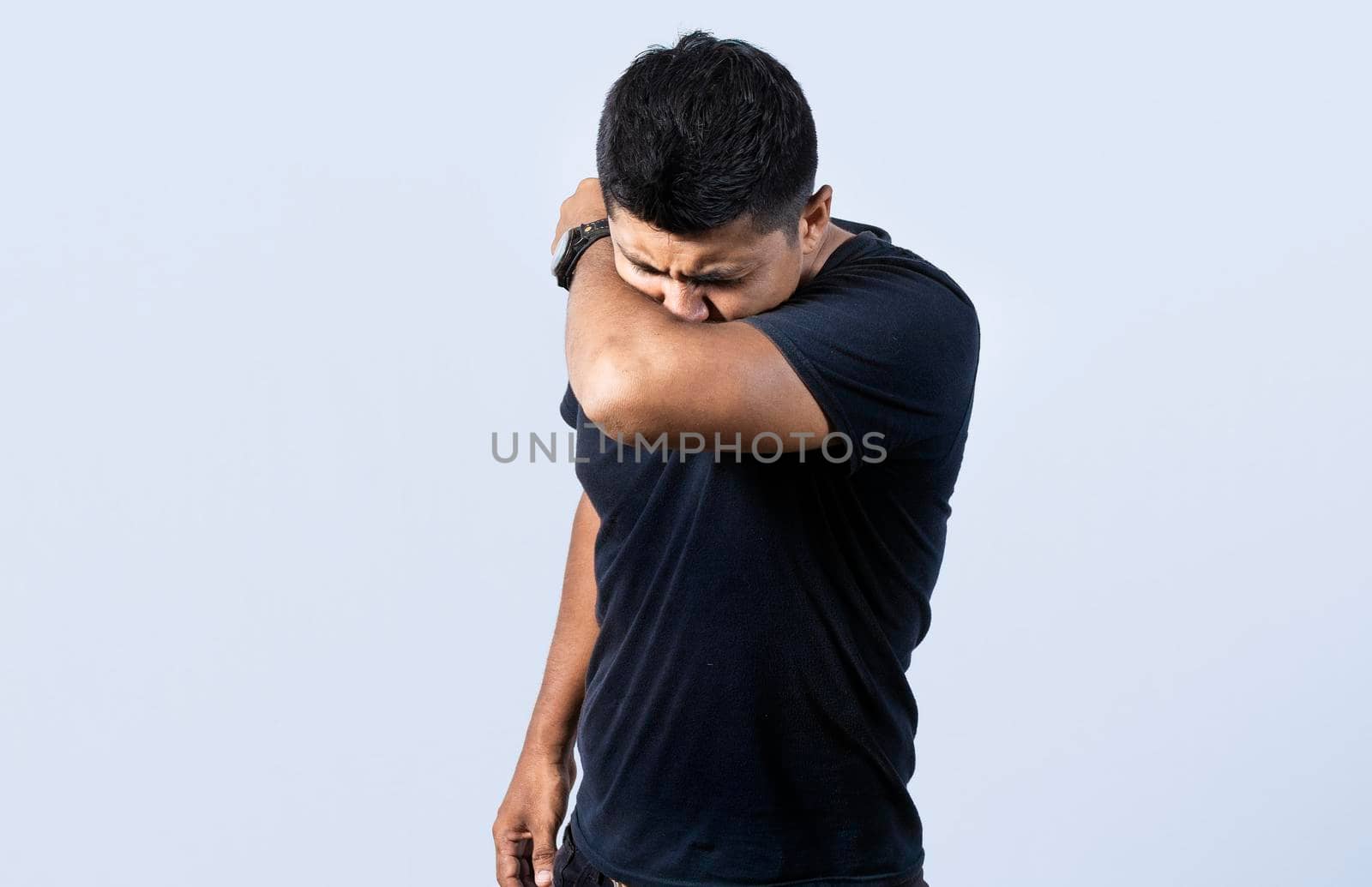 People sneezing with his elbow, A guy sneezing with his elbow on isolated background, concept of man having a cold sneezing with his elbow