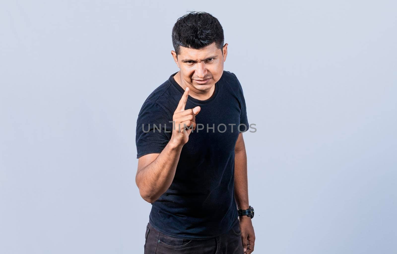Concept of angry person threatening head on, Hey you, be careful. people looking angry and warning, angry man threatening finger at camera
