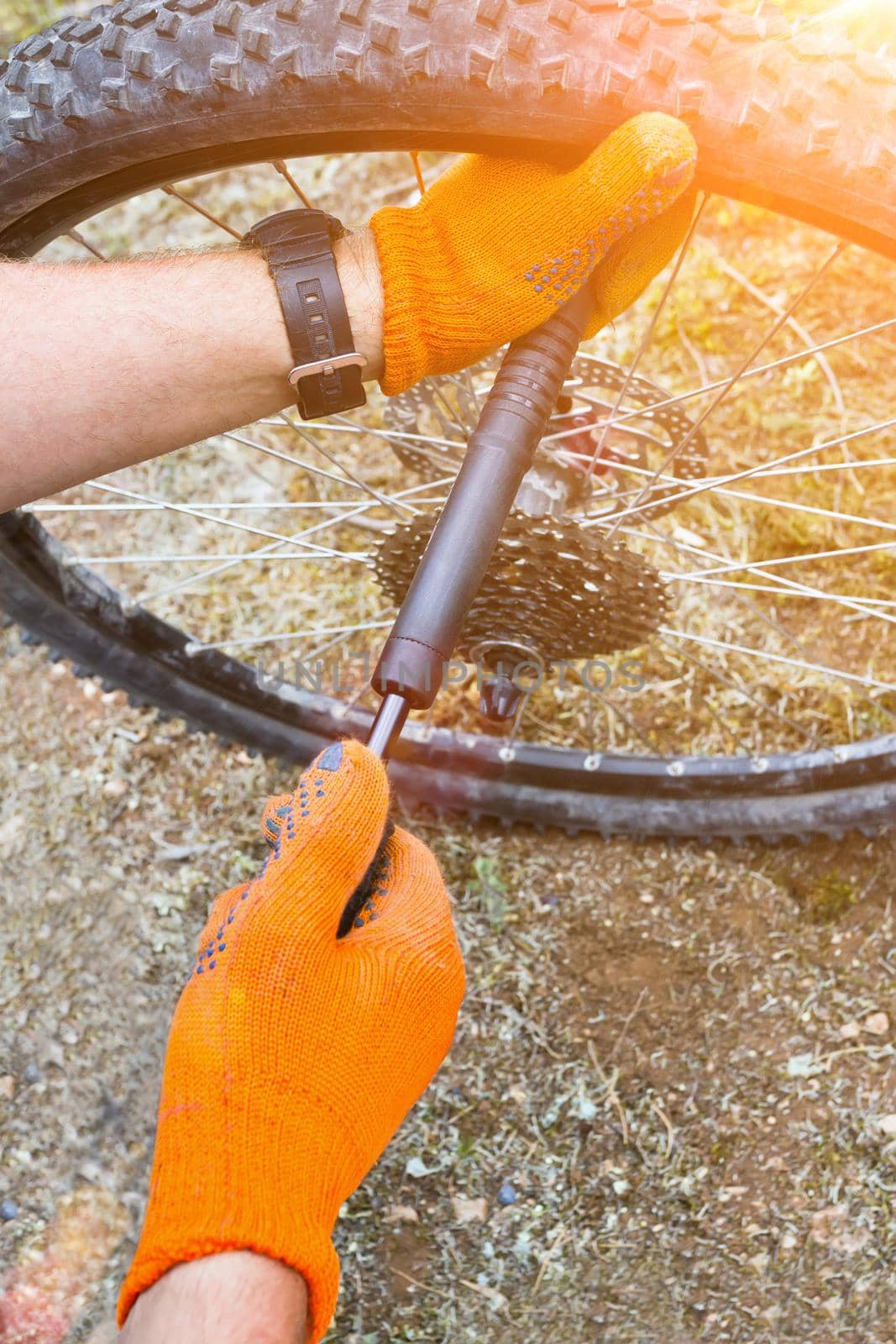 Closeup of mechanic pumping a bicycle tire. Toned image