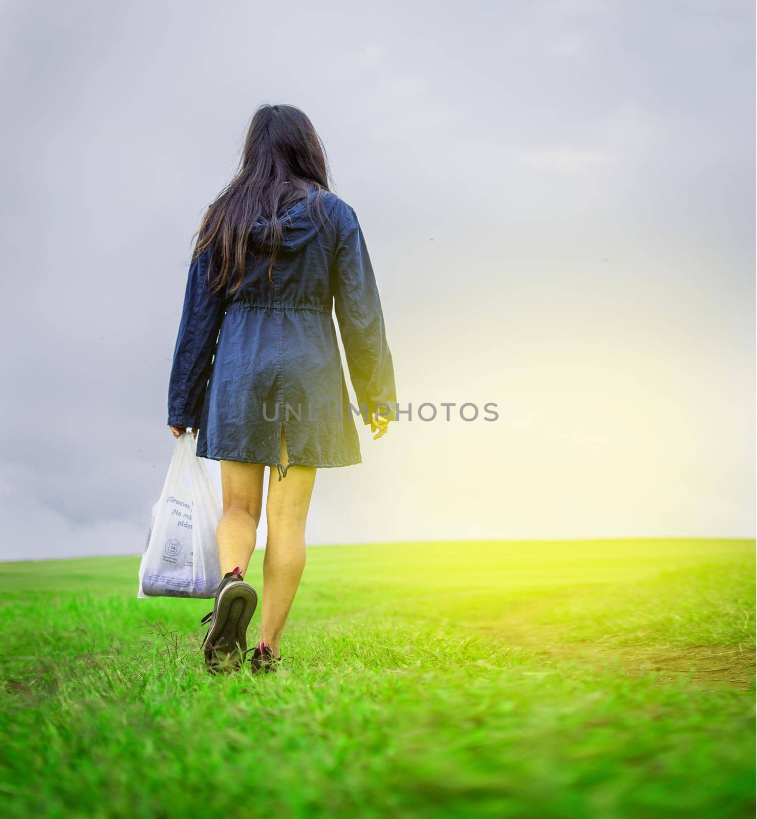 woman walking in the field with shopping bags, woman walking on a road in the field