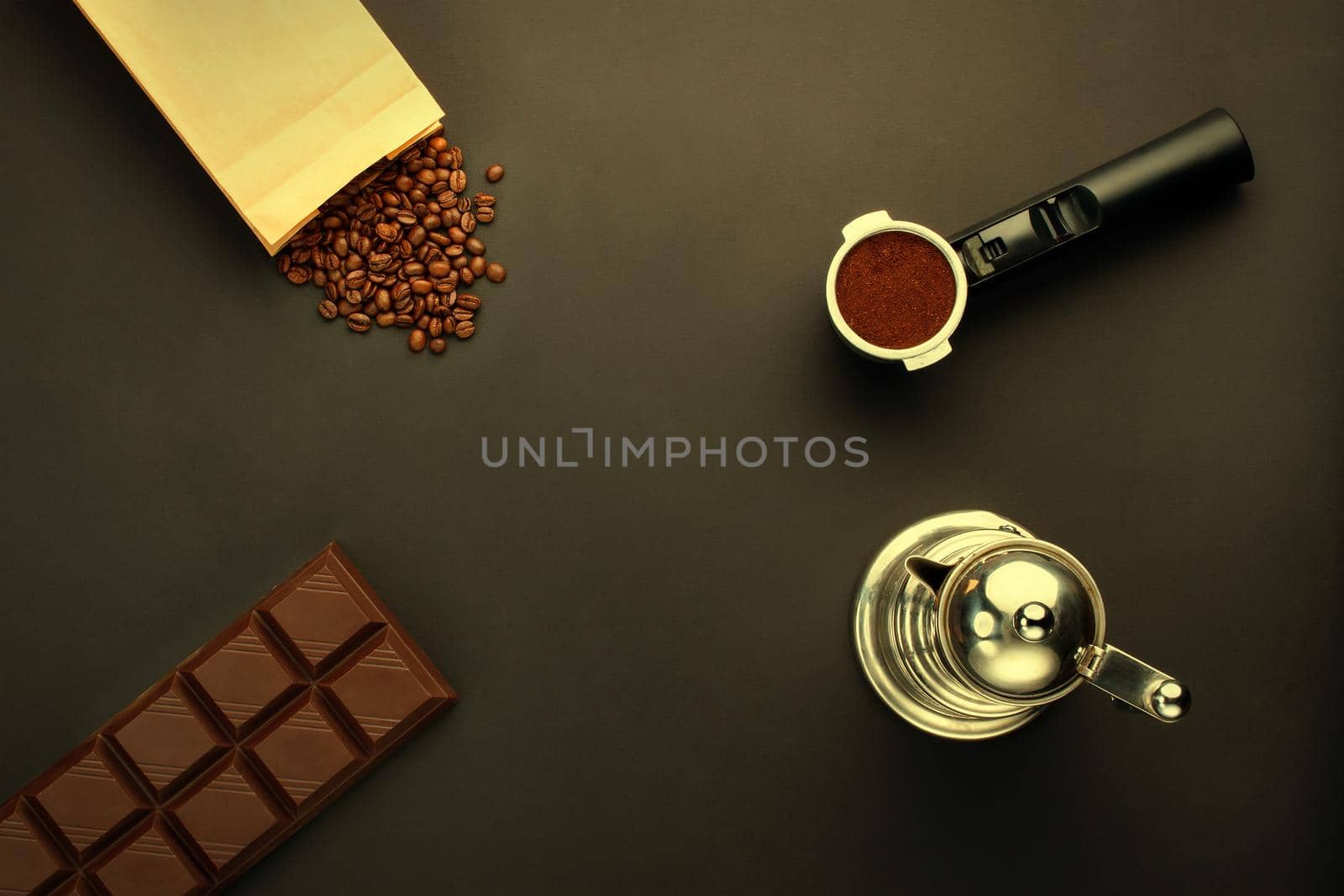 Coffee espresso in a holder, coffee-beans, bar of chocolate, coffee-pot