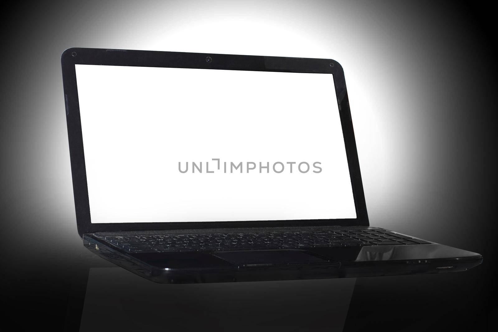 black laptop on black background with reflection