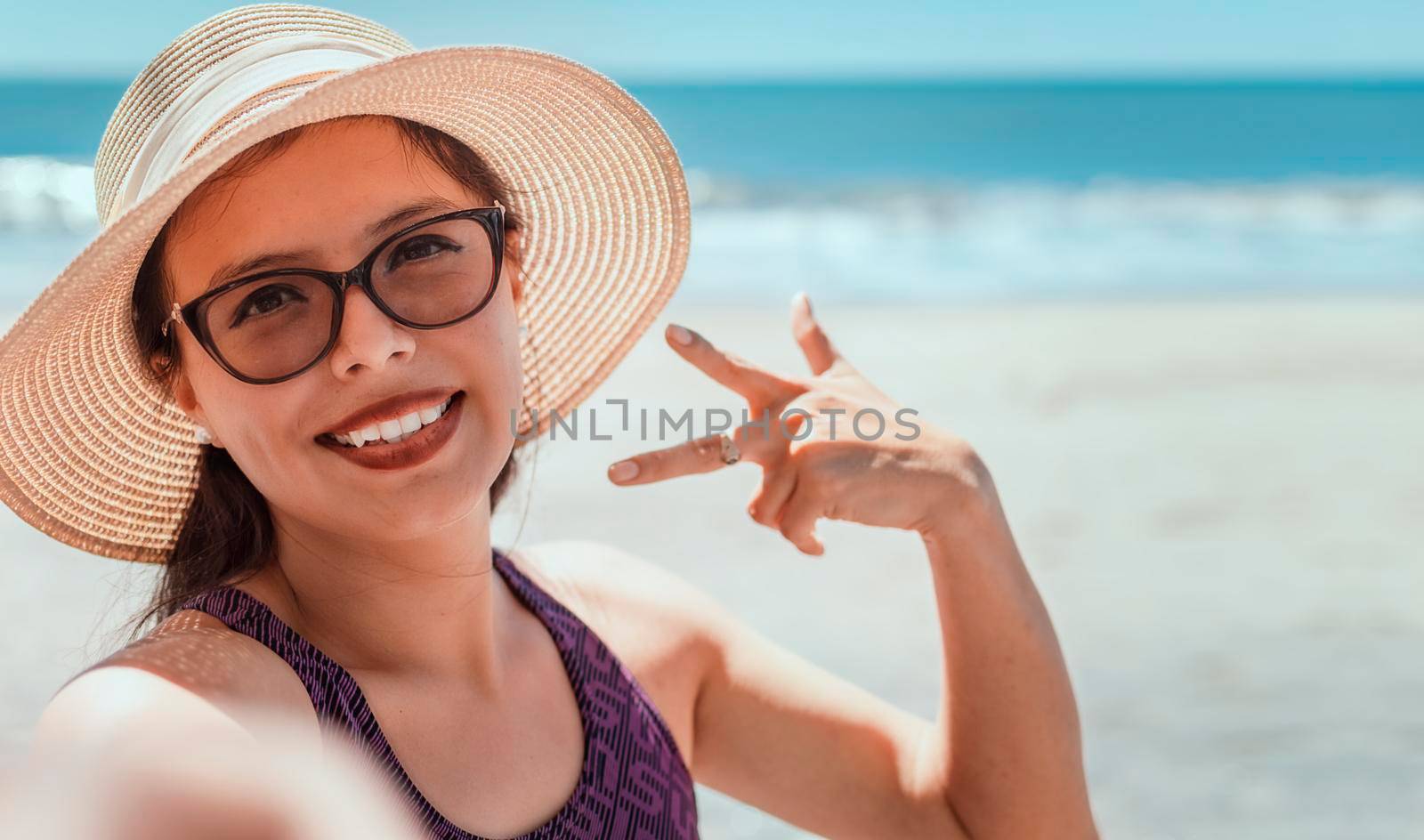 Pretty girl taking a selfie on the beach, happy pretty girl taking a selfie on the beach, vacation concept