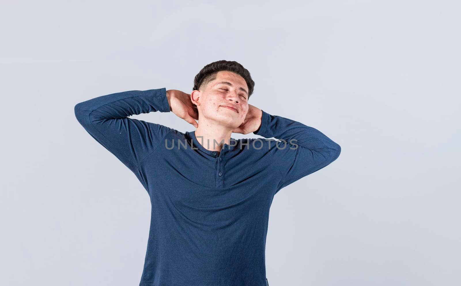 Relaxed man with closed eyes with hands behind his head, Relaxed smiling guy with hands behind his head, Concept of relaxed man with free time, Satisfied man with hands behind his head