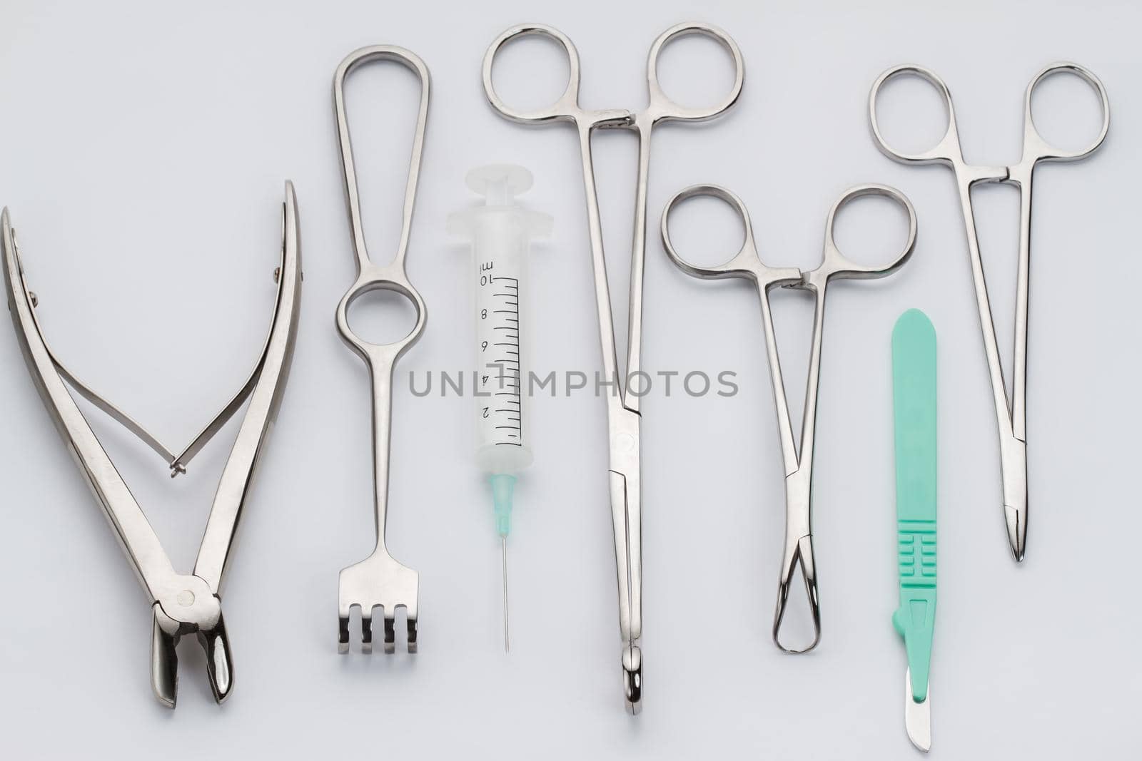 Overhead view of various surgical instruments - syringe, tongs etc.