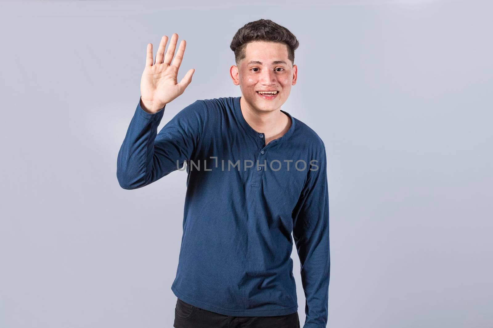 Man raising arm and waving friendly, isolated handsome man saying hi, friendly face man saying goodbye, concept of man saying hi on isolated background