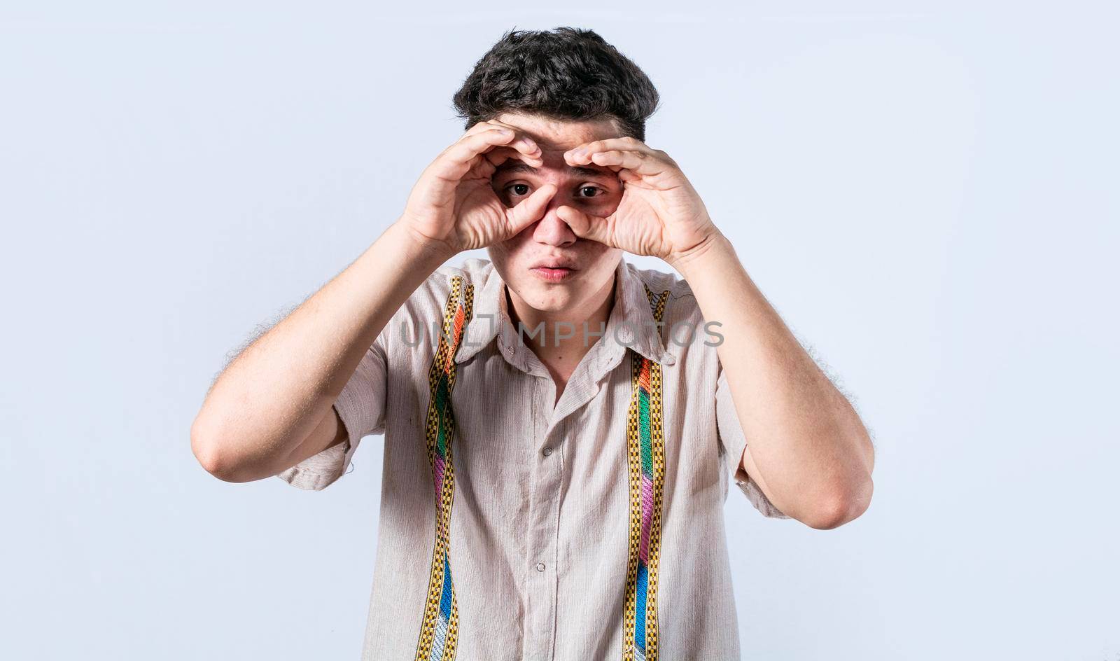 Man making binoculars gesture, Curious man making binoculars gesture, Guy on isolated background making binoculars gesture, man using his fists as binoculars