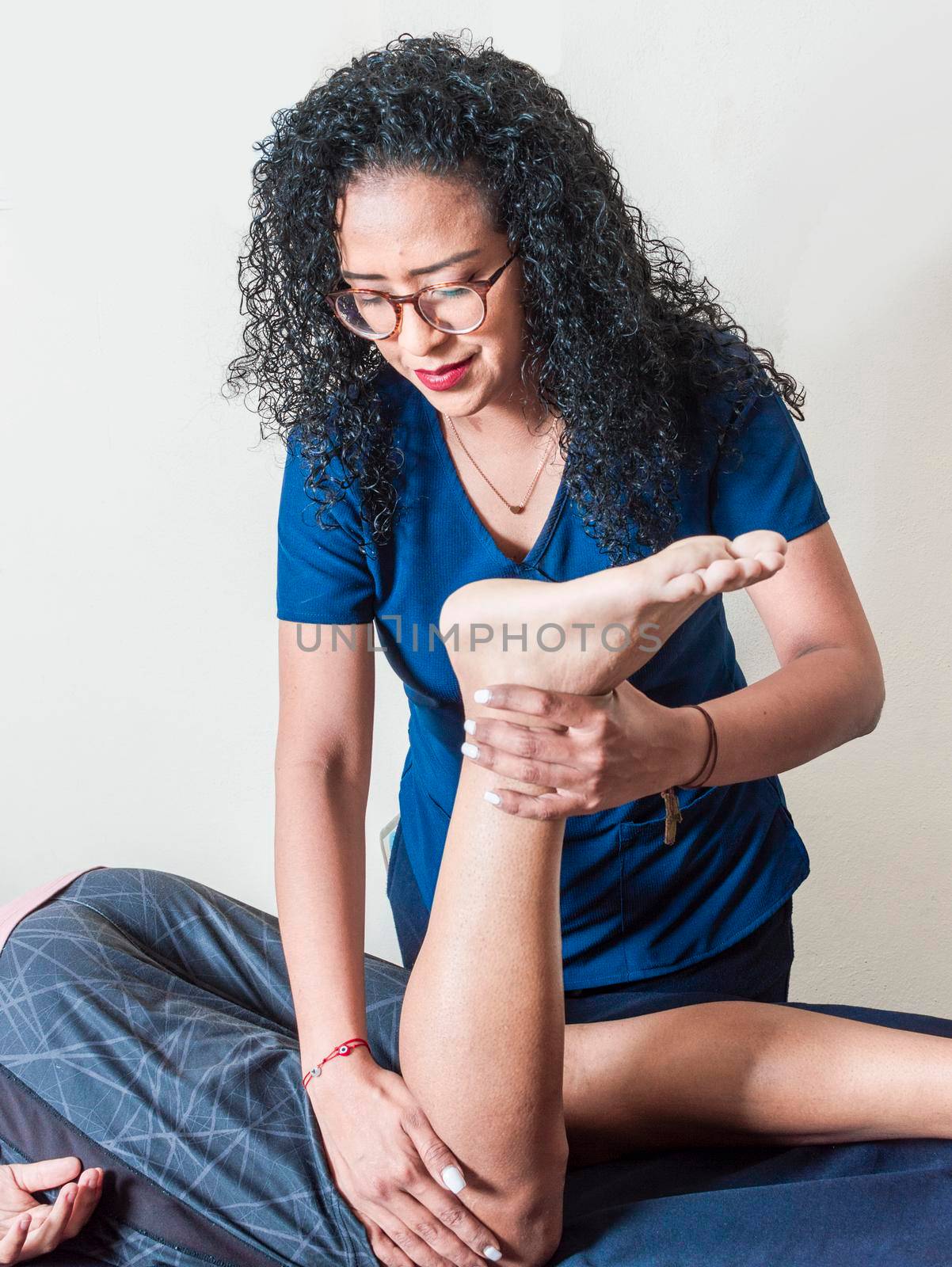 Knee flexion physiotherapy, rehabilitation concept, Physiotherapist with patient by isaiphoto