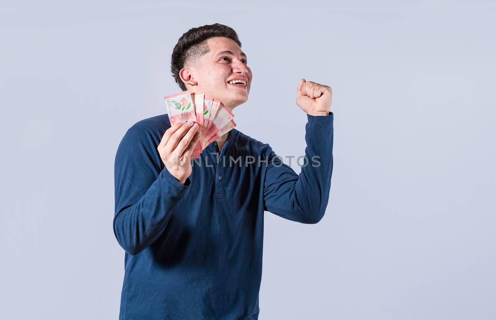 Excited man with money in his hand, astonished man with banknotes in his hand, concept of man earning money