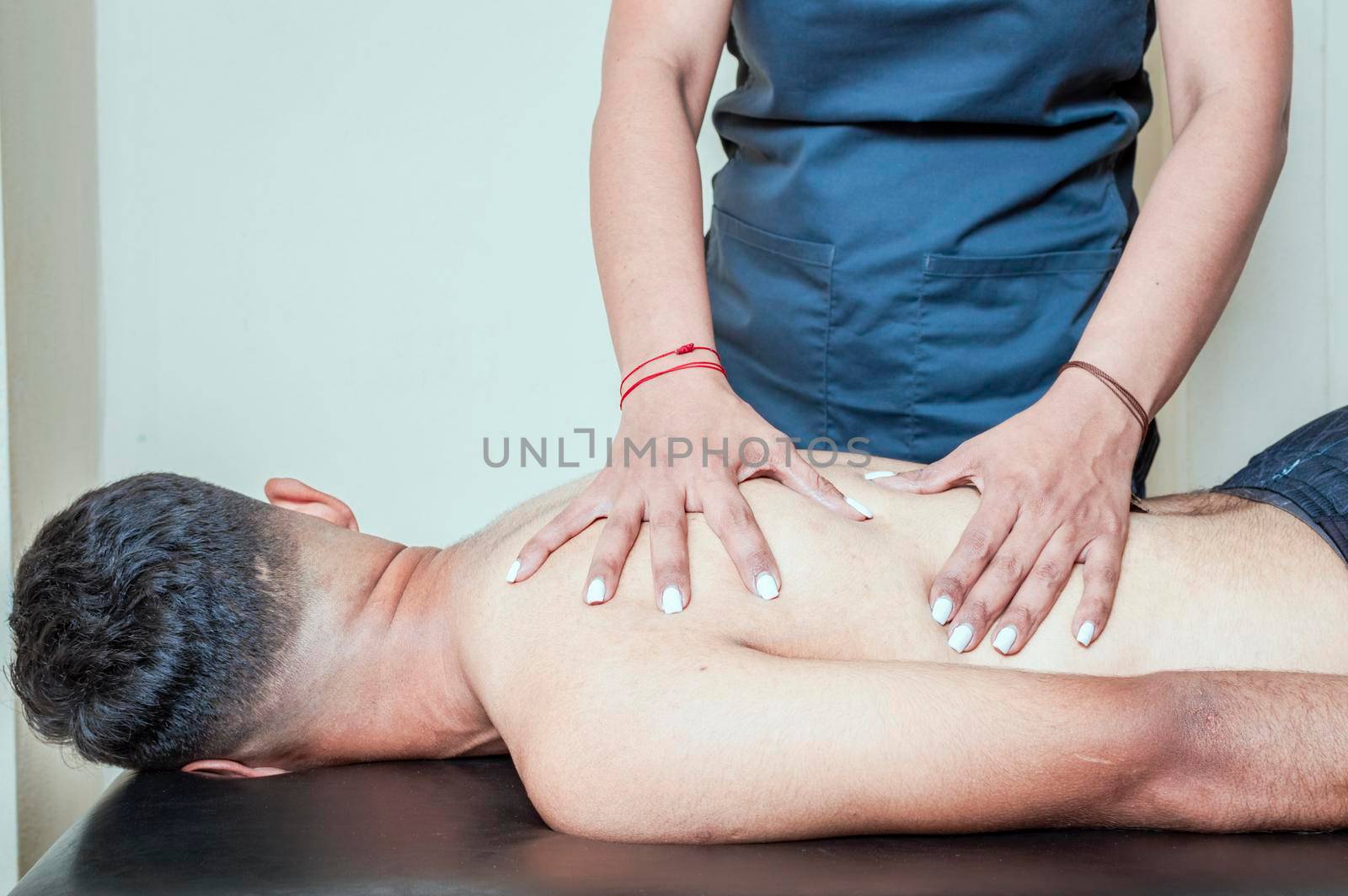 man having chiropractic back adjustment. physiotherapist curing patient's spine problems, Rehabilitation of sports injuries.