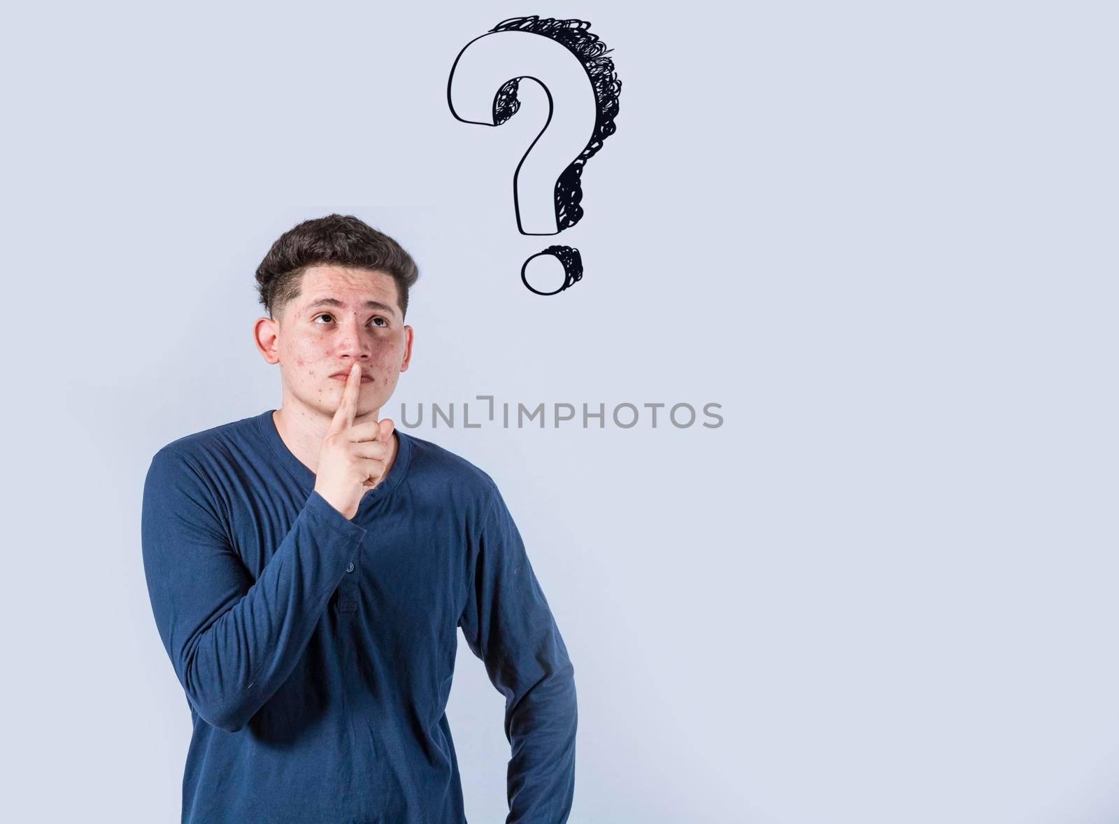 Thoughtful young man looking up with exclamation marks, Thoughtful man with exclamation marks on isolated background, Indecisive man looking up , Concept of man asking with exclamation marks
