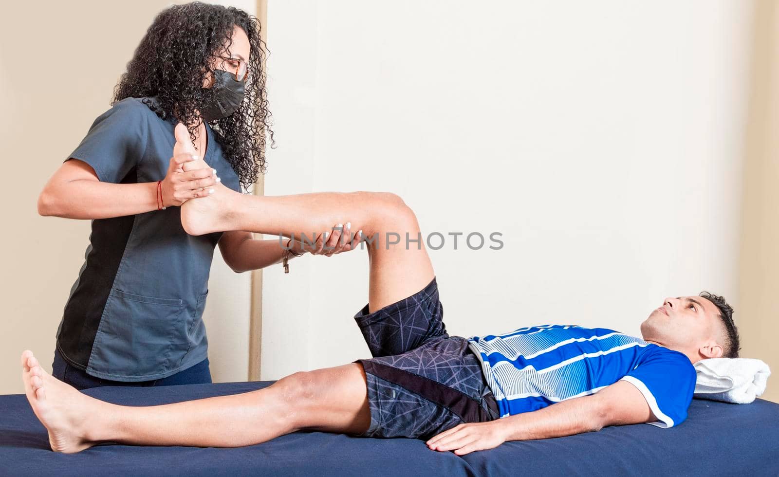 Knee rehabilitation physiotherapy, female doctor with patient undergoing knee treatment by isaiphoto