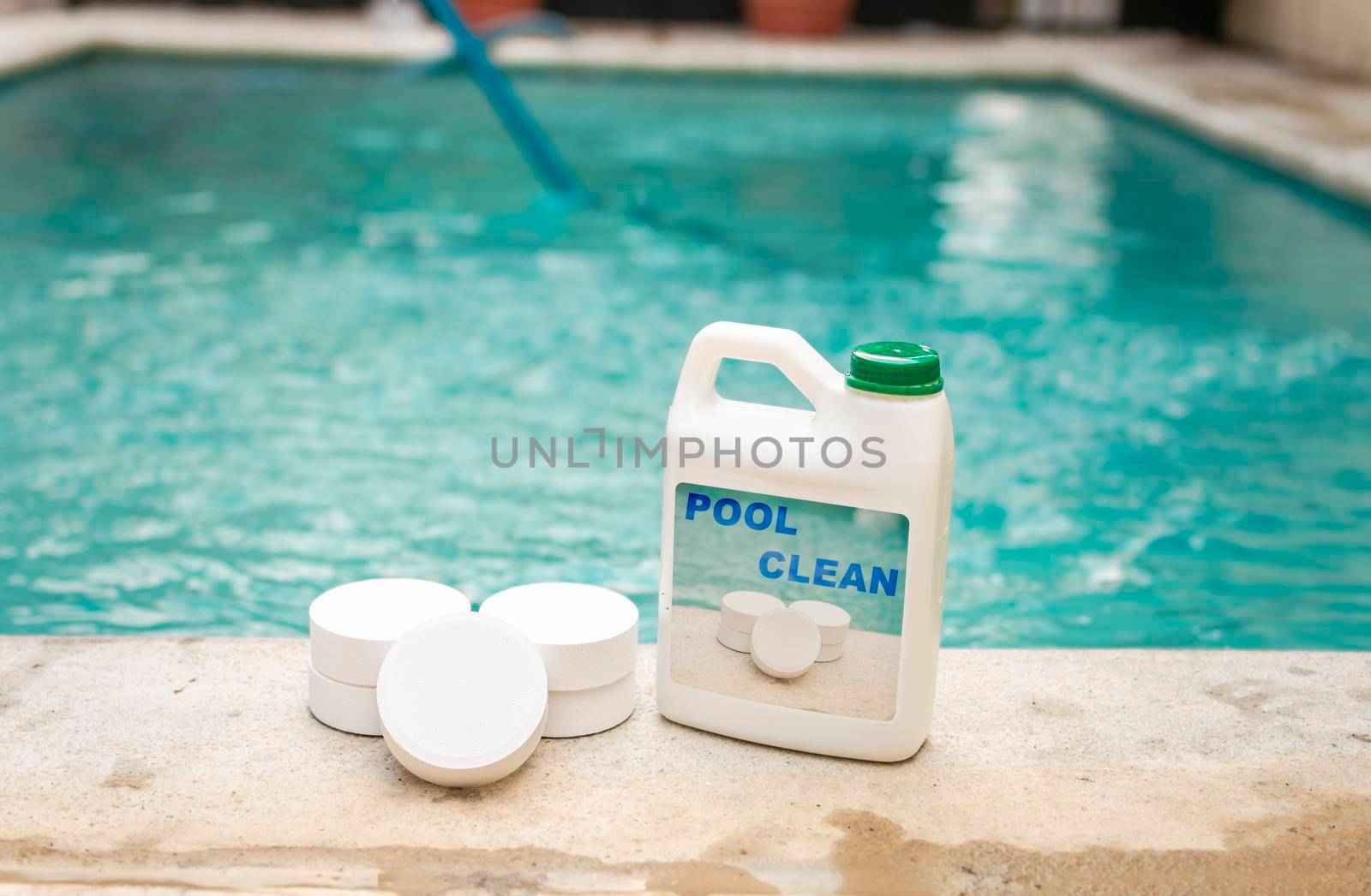 Pool cleaning chlorine tablets kit, pool cleaning chlorine tablets close up on the edge of a swimming pool, pool sanitizing chlorine tablets concept
