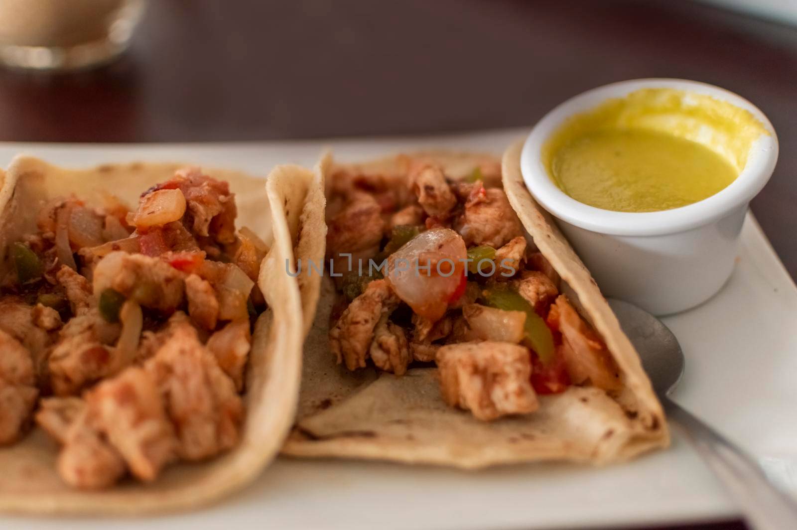Close up of mexican chicken tacos, chicken tacos with salsa served on the table, tacos served on the table