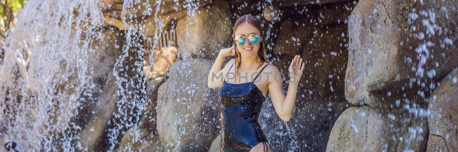 Young joyful woman under the water stream, pool, day spa, hot springs. BANNER, LONG FORMAT