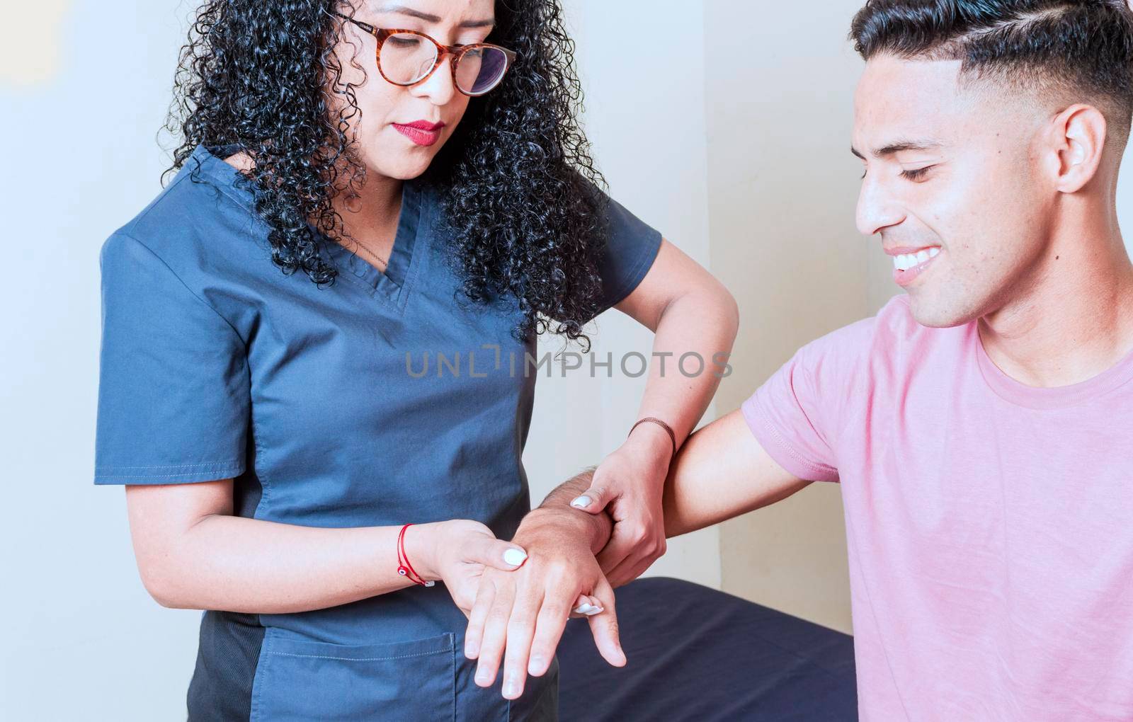 Physiotherapist with patient wrist assessment, wrist rehabilitation physiotherapy, hand wrist assessment