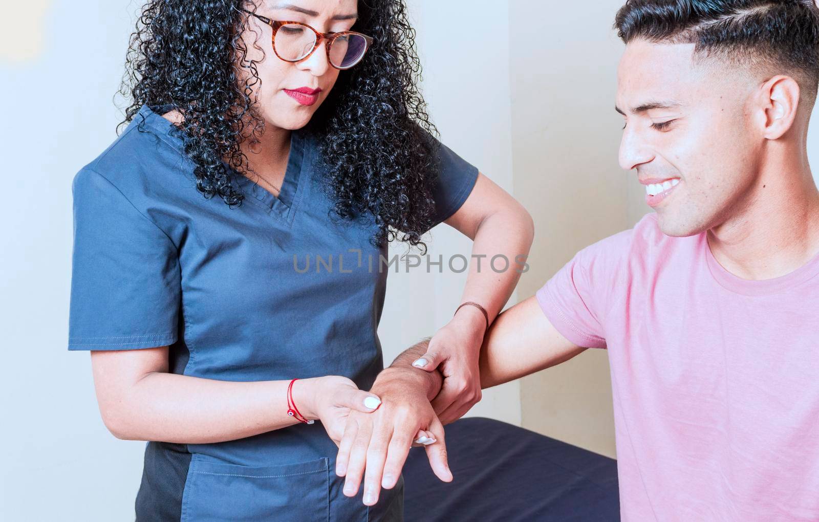 Physiotherapist with patient wrist assessment, wrist rehabilitation physiotherapy, hand wrist assessment by isaiphoto