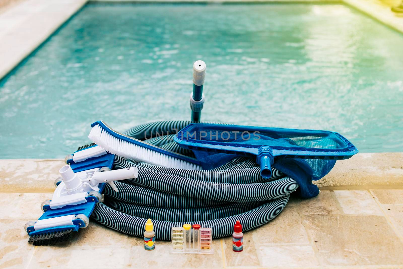 Pool cleaning and maintenance tools, image of pool cleaning and maintenance kit, vacuum cleaner, ph test, leaf picker and pool sweeper