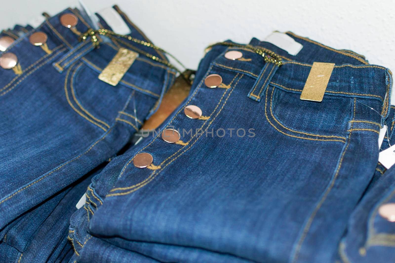 Close up of blue jeans over others, clothing sale concept, jeans sale concept