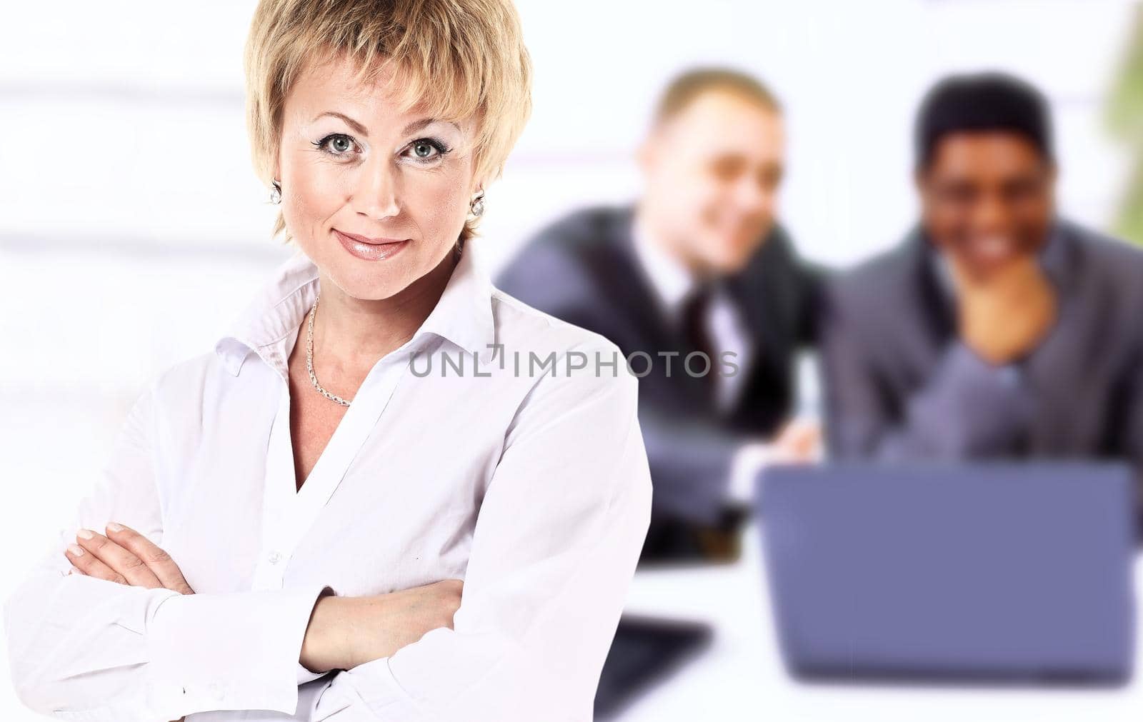 Business lady with positive look and cheerful smile posing for the camera