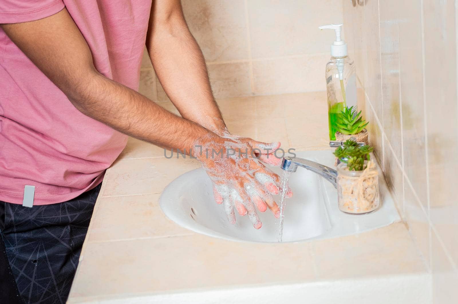 Close up of a man washing their hands with soap, concept of correct hand washing, ways to prevent covid19