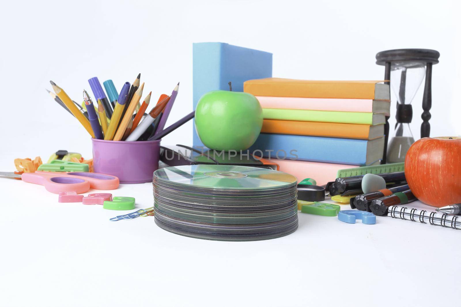 stack of CDs and school supplies isolated on white background.photo with copy space.