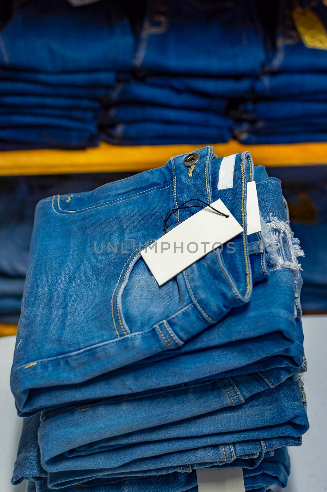 Close up of blue jeans on others with copy space; Various jeans on others with space for text