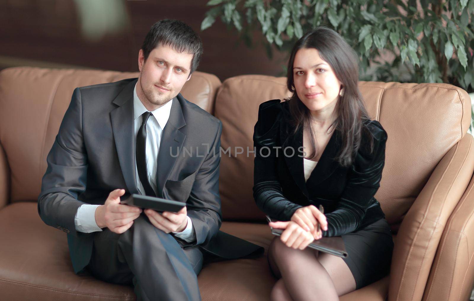 young businessmen discuss business document sitting on the couch in the business center.photo with copy space