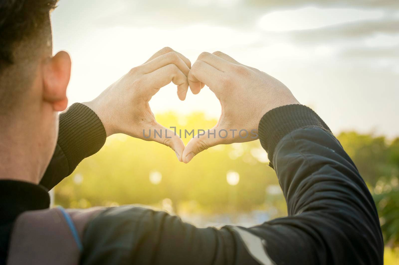 Close up of two hands together in a heart shape, hands together in a heart shape, young man putting fingers together in a heart shape
