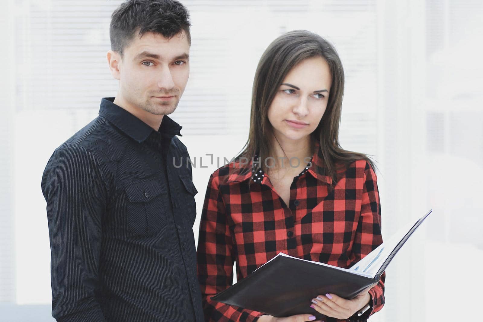 business couple with clipboard discussing working issues.