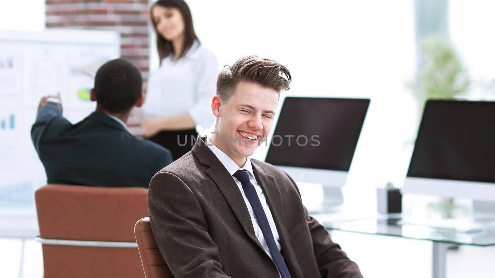 portrait of young employees sitting near the desktop in the office.